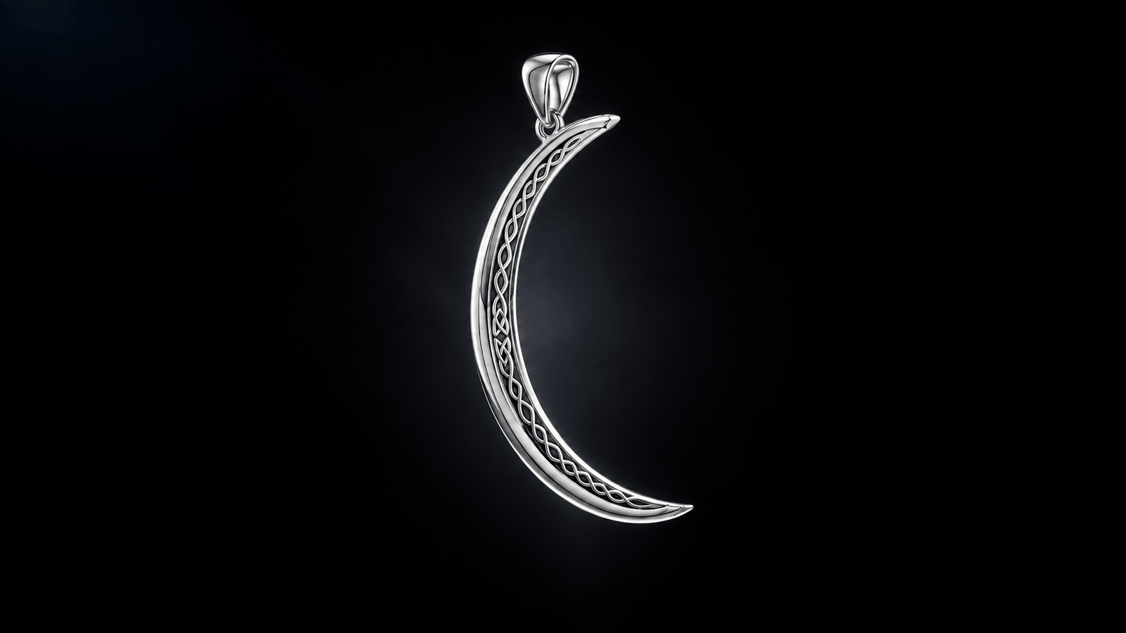 Sterling silver crescent moon pendant with Celtic knotwork against a dark background