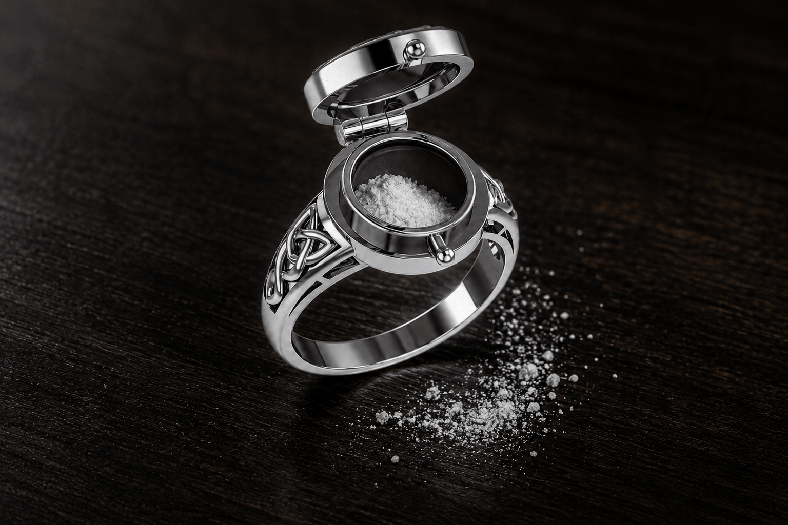Open poison ring containing powder representing arsenic, with powder spilled on a dark wooden table sterling silver Celtic
