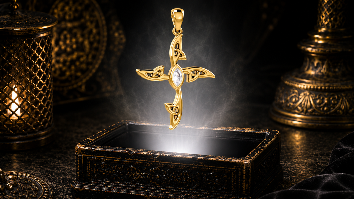 Solid 14K gold contemporary Celtic cross pendant with a clear cubic zirconia gemstone floating above an ornate jewelry box in a refined dark luxury setting with warm candlelight, cinematic lighting, and a mystical atmosphere.