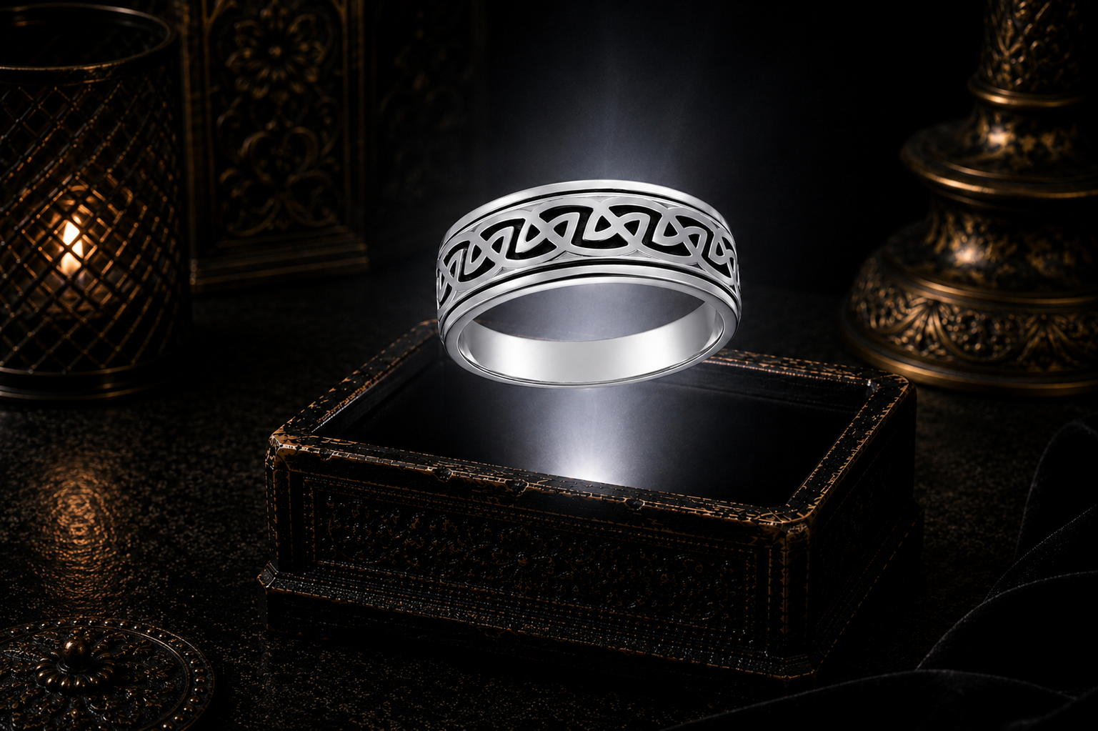 Solid white gold Celtic knotwork spinner ring floating above a glowing antique jewelry box in a cinematic luxury setting 14K