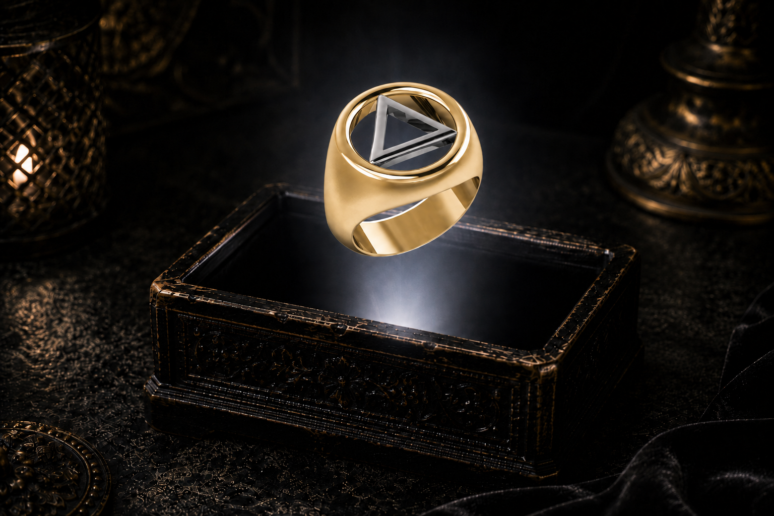 Gold Recovery ring with a white gold triangle inside an open circular frame, floating above an antique jewelry box.