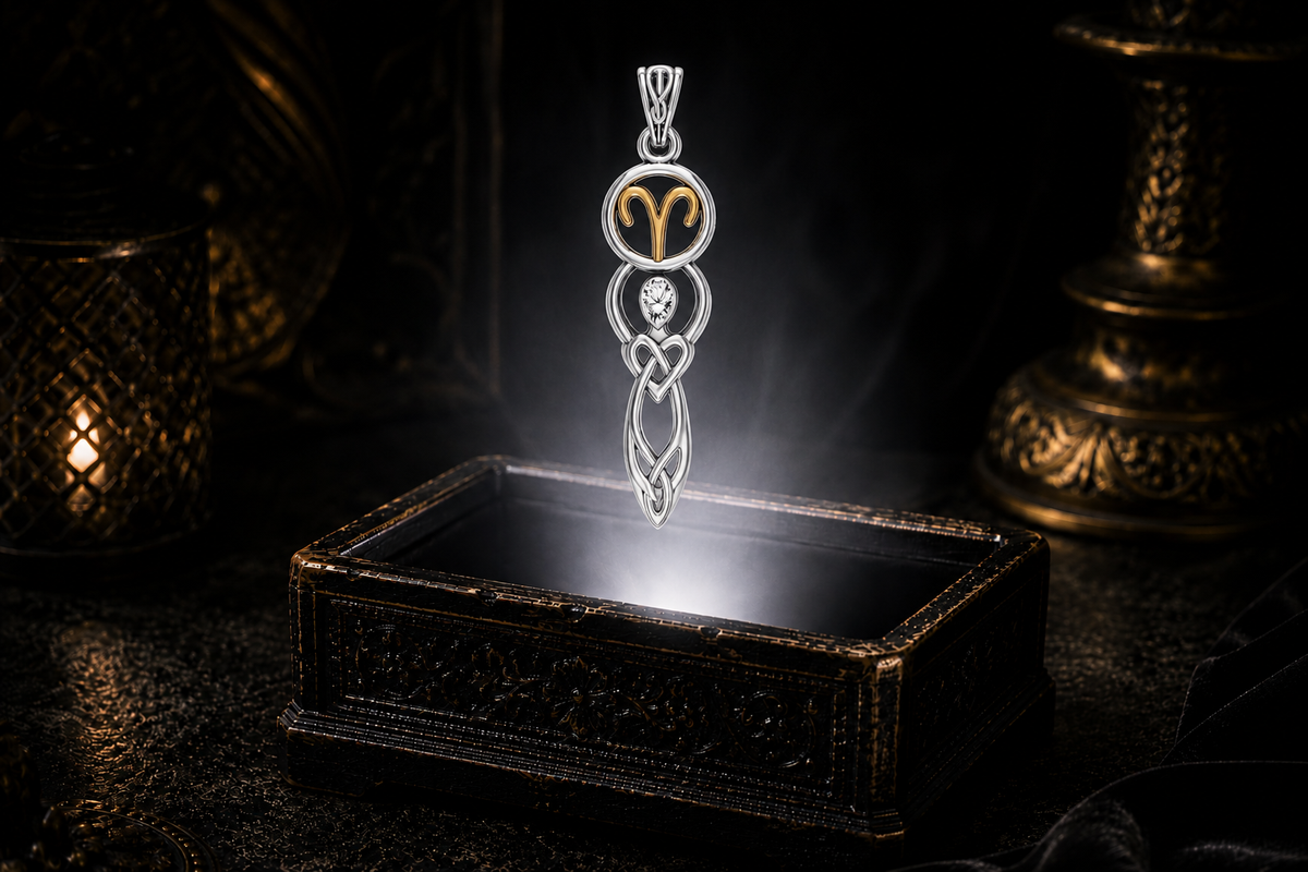 Sterling silver Aries birthstone pendant with natural white topaz, gold accents, and Celtic goddess symbolism showcased above an antique jewelry box surrounded by mystical light and shadow.