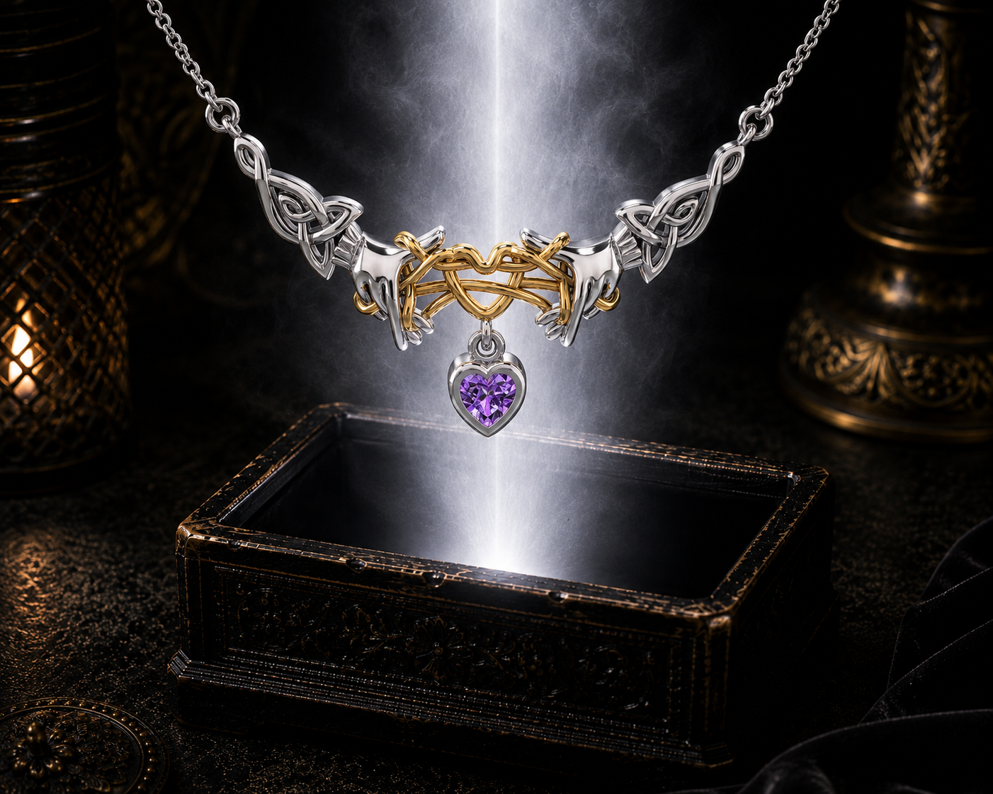 Sterling silver Ayatori Celtic heart necklace with gold accents and amethyst gemstone floating above an ornate jewelry box surrounded by soft glowing light in a dark luxury setting.