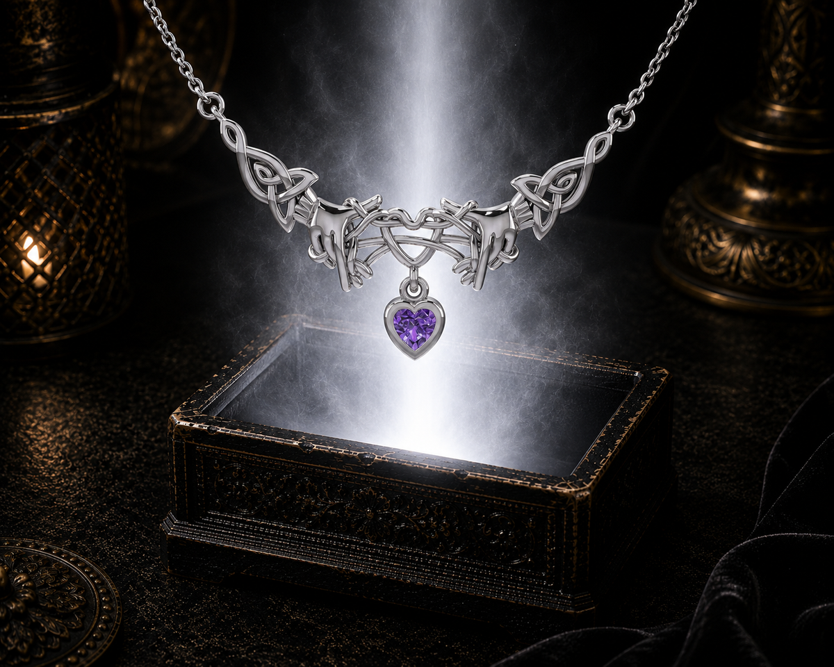 Sterling silver Ayatori Celtic heart necklace with amethyst gemstone floating above an ornate jewelry box surrounded by soft glowing light in a dark luxury setting.
