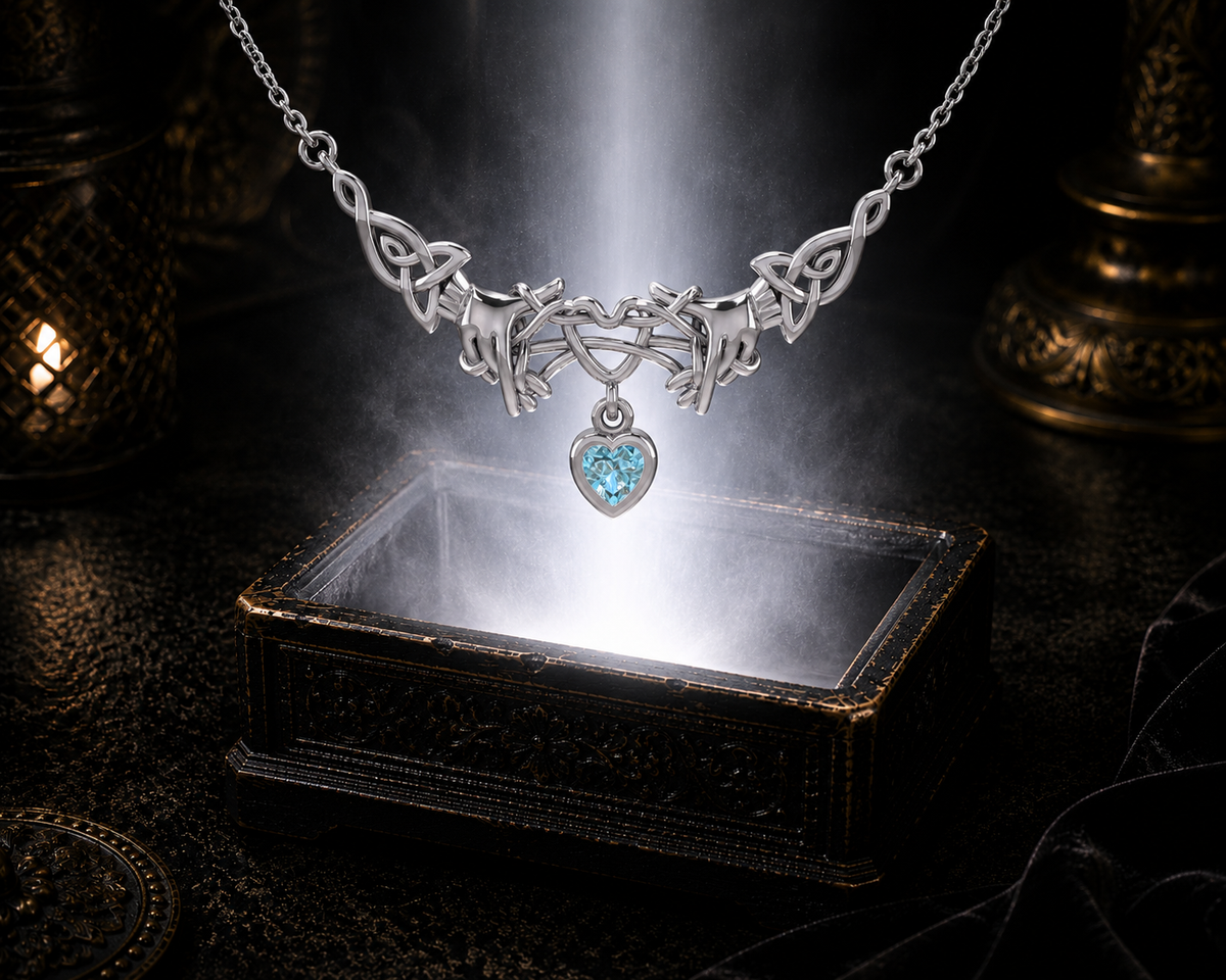 Sterling silver Ayatori Celtic heart necklace with blue topaz gemstone displayed above a luminous jewelry chest illuminated by radiant light in a cinematic luxury environment.