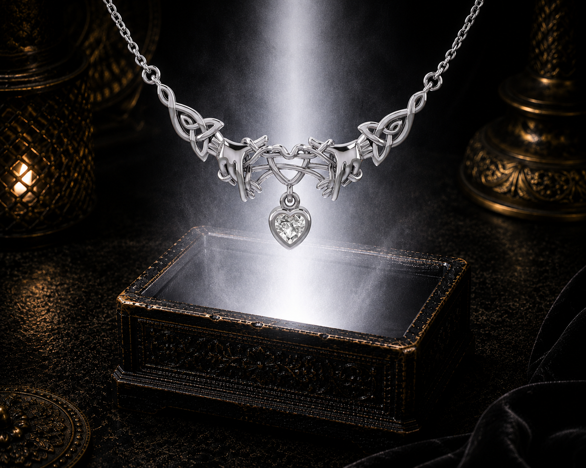 Sterling silver Ayatori Celtic heart necklace with cubic zirconia gemstone displayed above a luminous jewelry chest sparkling with radiant light in a dark cinematic setting.