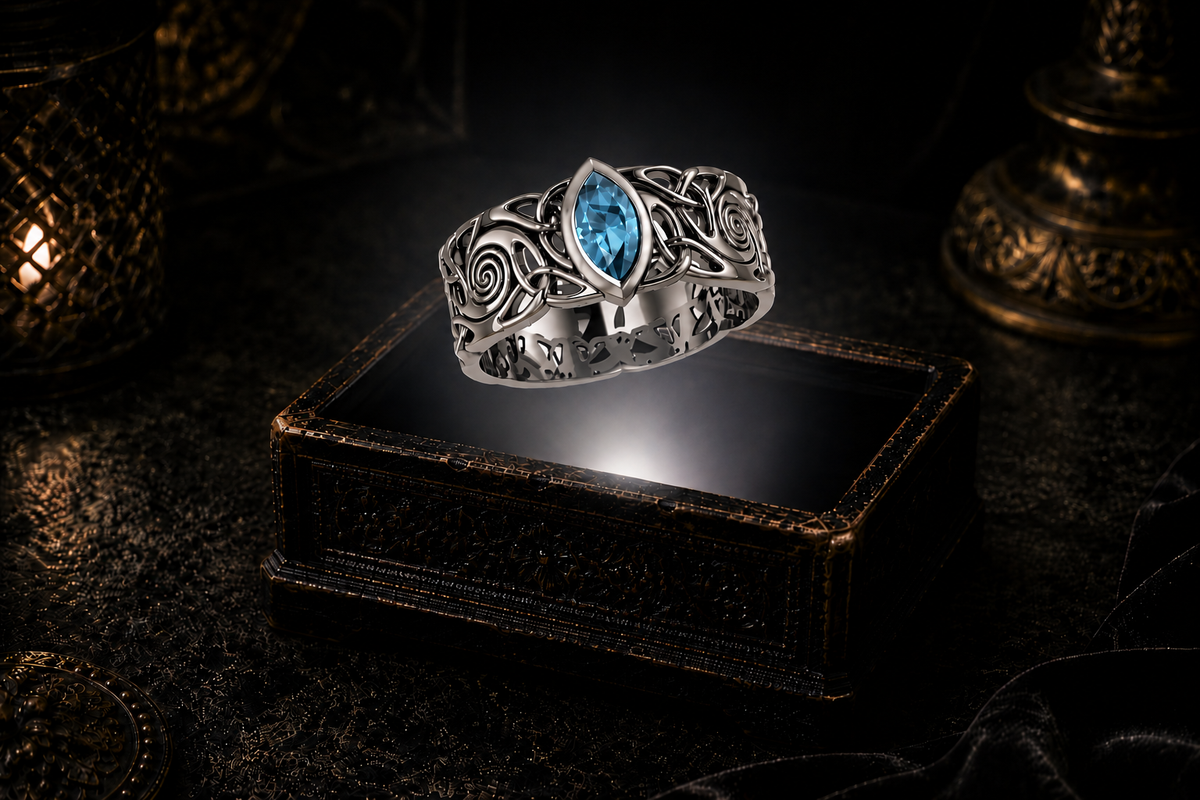 Sterling silver Celtic knot ring with blue topaz gemstone suspended above an illuminated antique jewelry box in a cinematic gothic setting