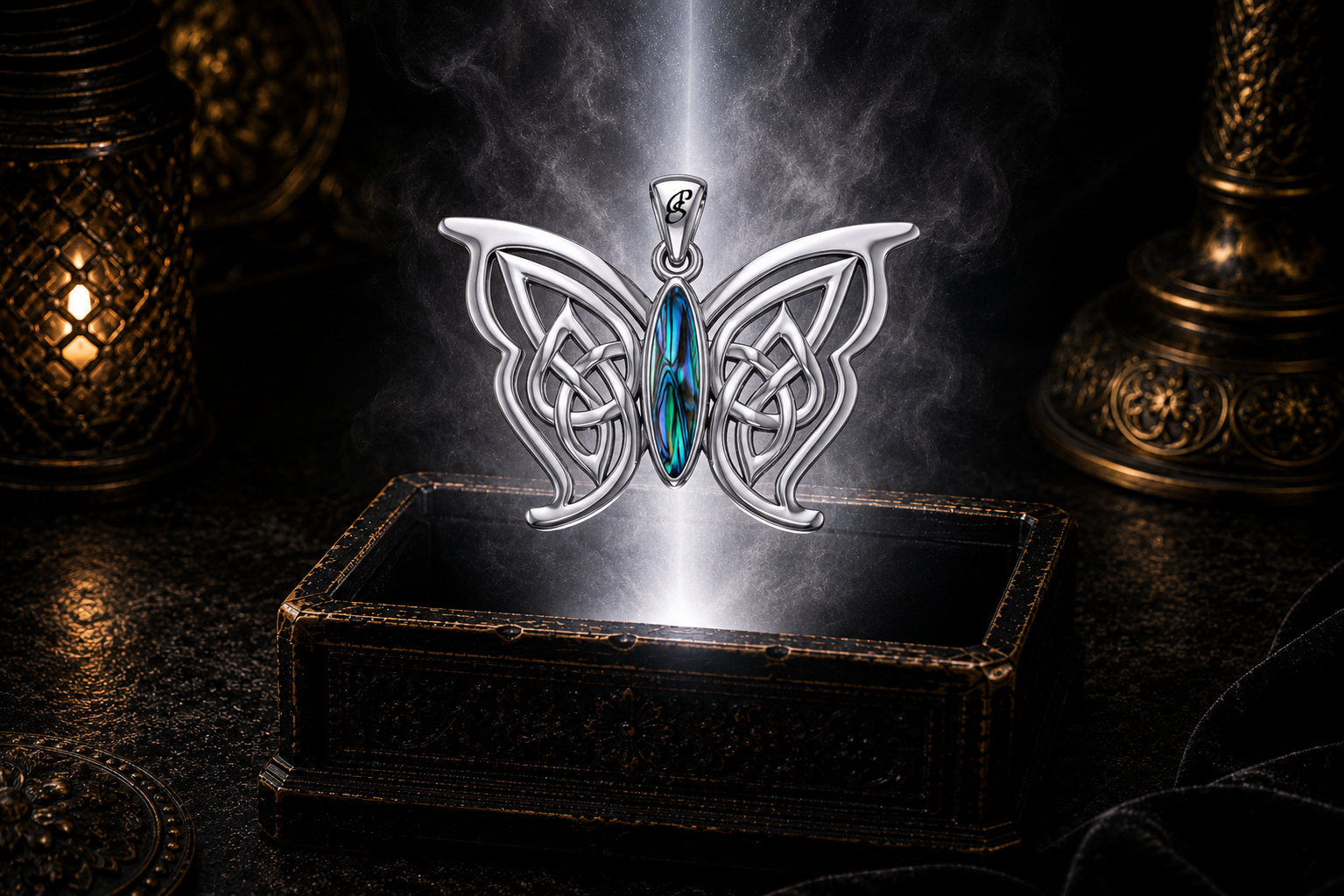 Sterling silver Celtic butterfly pendant with paua shell gemstone inlay floating above an ornate dark jewelry box surrounded by luminous white light in a cinematic luxury setting.
