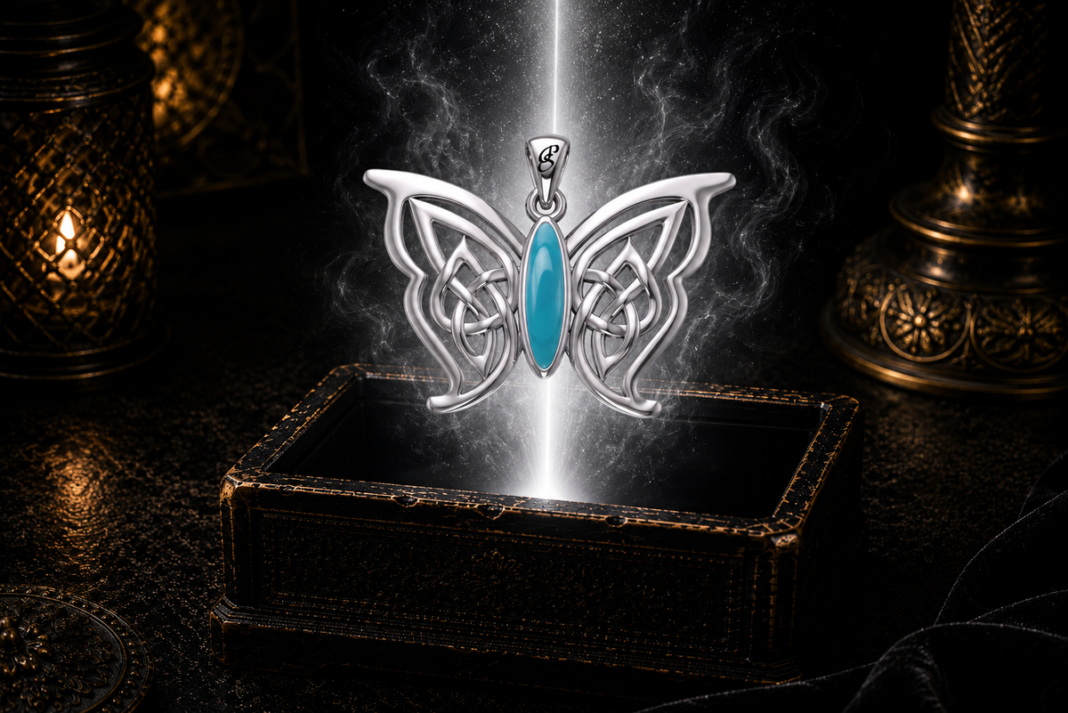 Sterling silver Celtic butterfly pendant with turquoise gemstone inlay floating above an ornate dark jewelry box surrounded by luminous white light in a cinematic luxury setting.