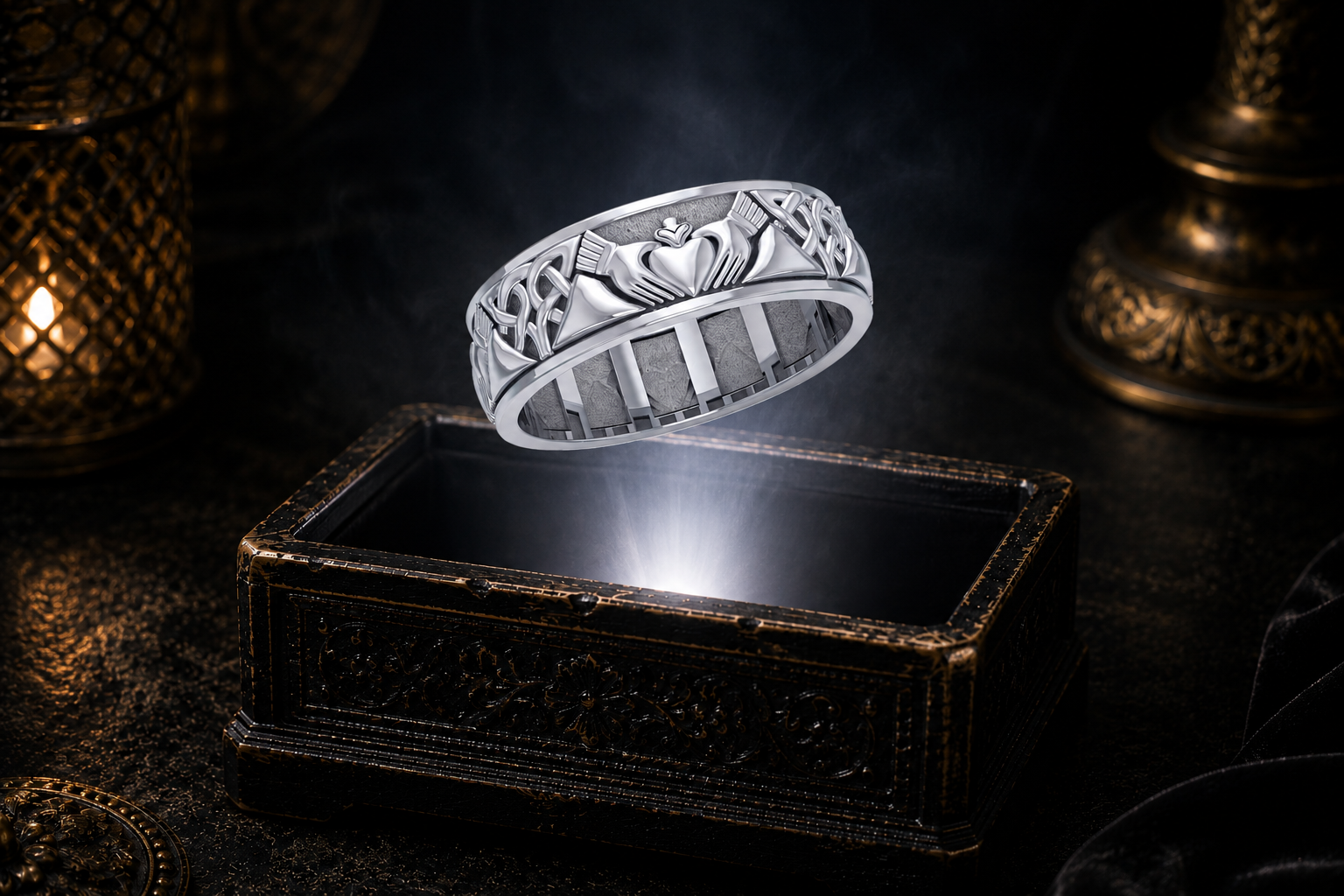 Sterling silver Celtic Claddagh spinner ring with Celtic knotwork floating above an antique jewelry box in a beam of white light.
