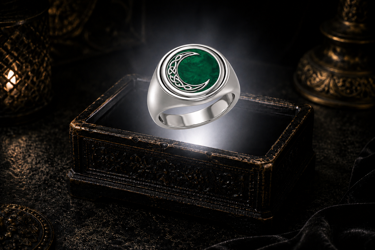 Sterling silver Celtic Crescent Moon flip ring with vibrant Emerald Glass gemstone displayed on a dark cinematic luxury jewelry background