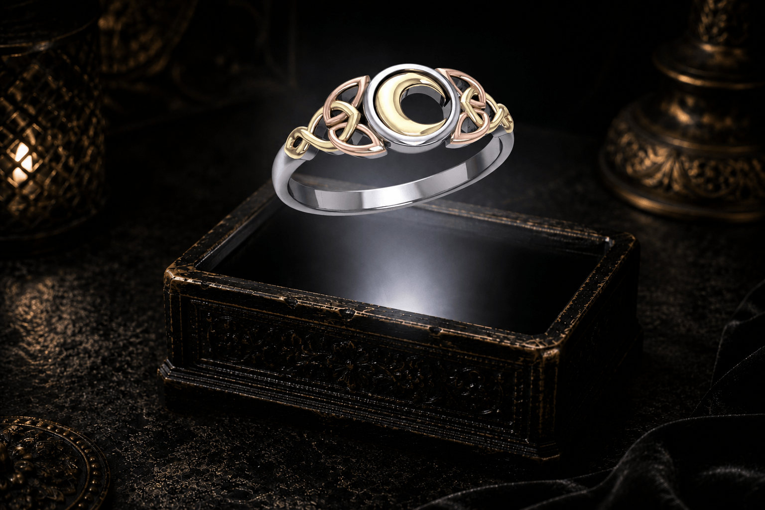 Celtic crescent moon and Trinity knot ring hovering above an ornate dark jewelry box in a neutral white beam of light.