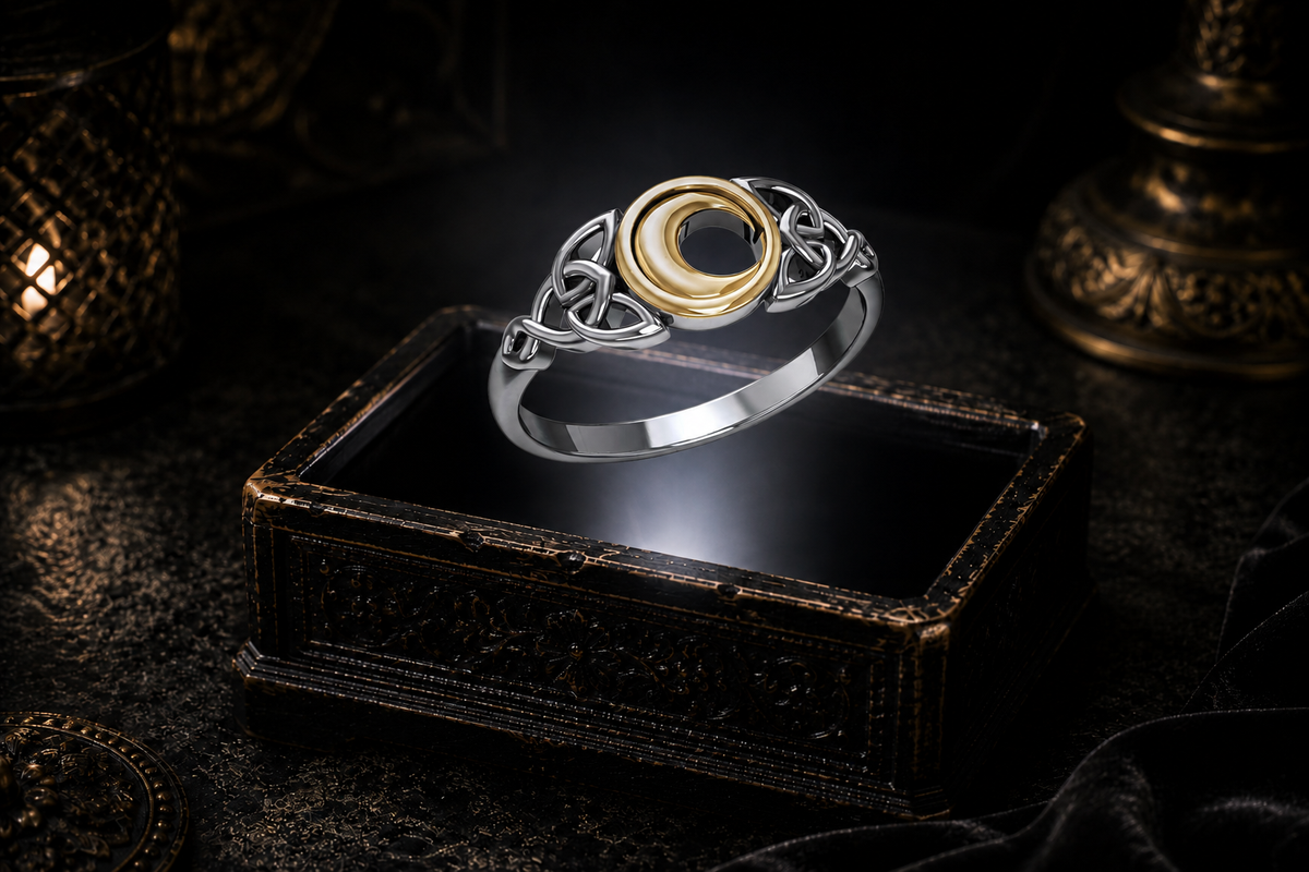 Celtic crescent moon ring in sterling silver with 14K gold vermeil and open knotwork on a white background
Sterling silver Celtic crescent moon ring with 14K gold vermeil hovering above an antique jewelry box in a neutral beam of light
