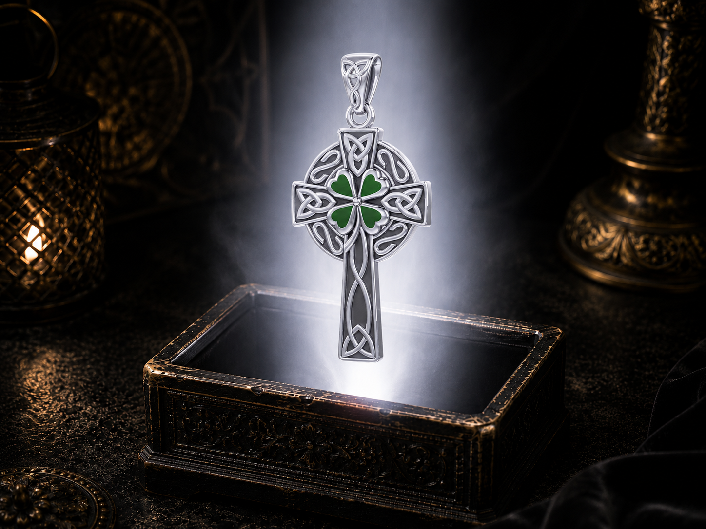 Sterling silver Celtic Cross pendant with a green Four Leaf clover centerpiece floating above an ornate jewelry box surrounded by soft glowing light in a dark luxury setting, featuring intricate Celtic knotwork and a circular Celtic cross design.