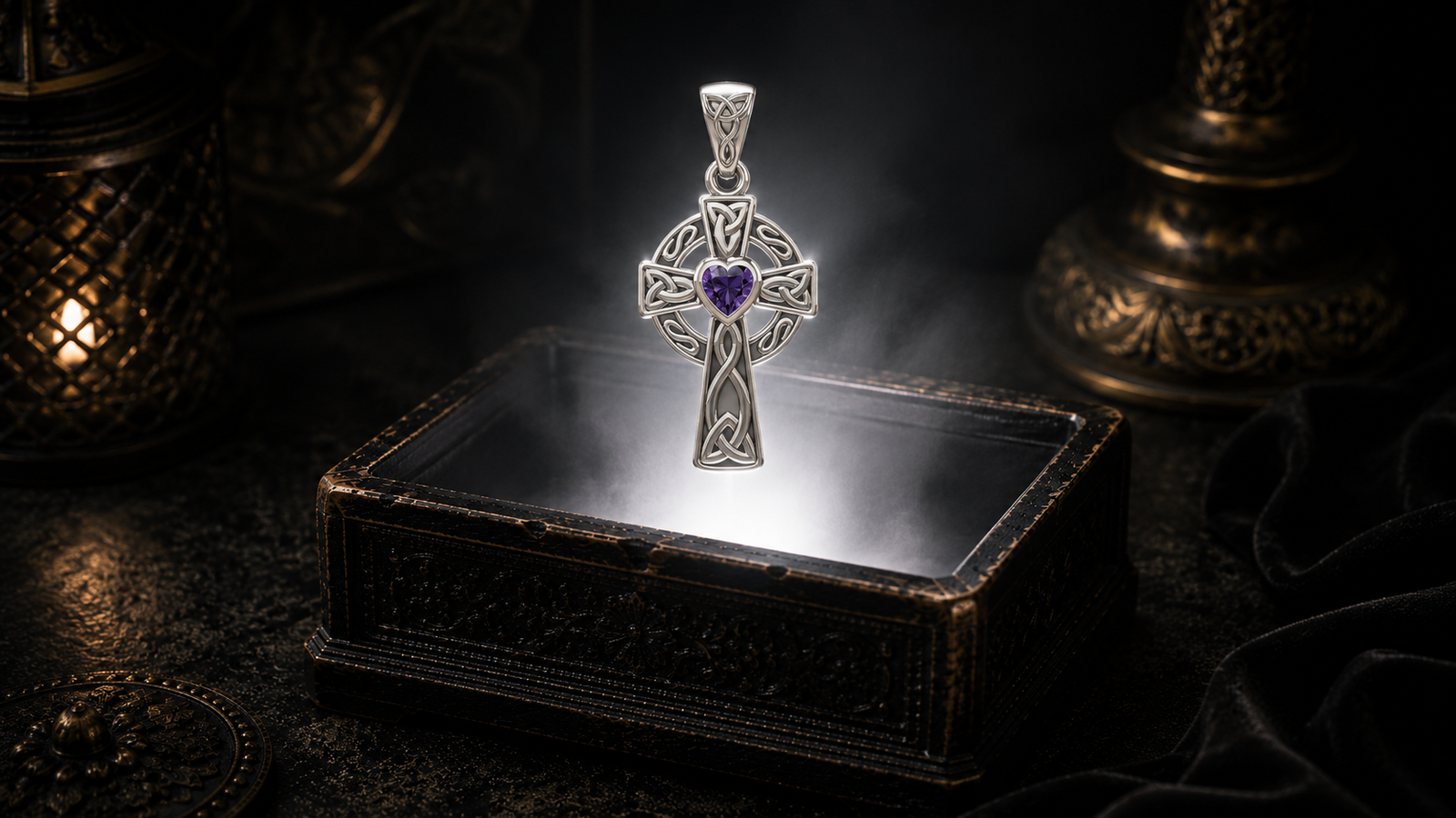 White gold Celtic Cross pendant with a heart-shaped garnet gemstone floating above an ornate jewelry box in a refined dark luxury setting with warm candlelight, cinematic lighting, and a mystical atmosphere.