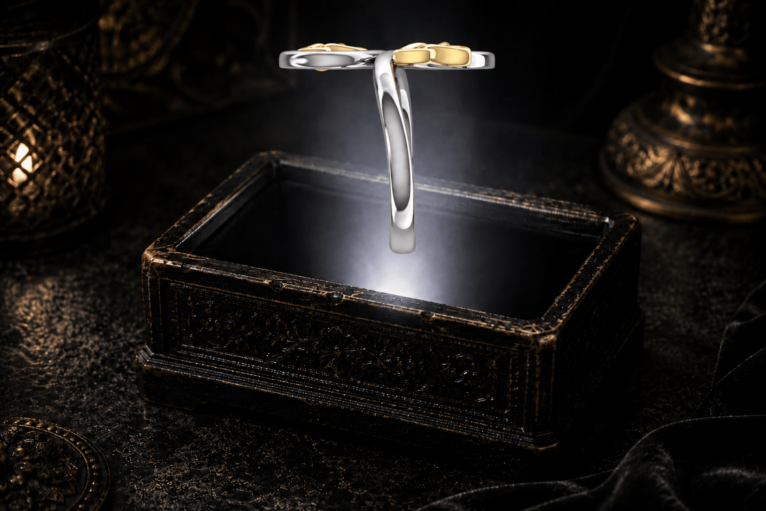 Celtic double Trinity knot ring in .925 sterling silver with two 14K gold Trinity knot accents, floating above an ornate black jewelry box.