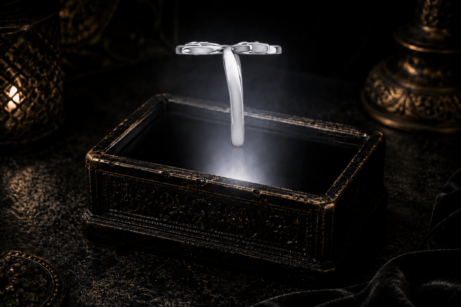 Sterling silver double Trinity knot ring floating above an antique jewelry box within a neutral white beam of light.