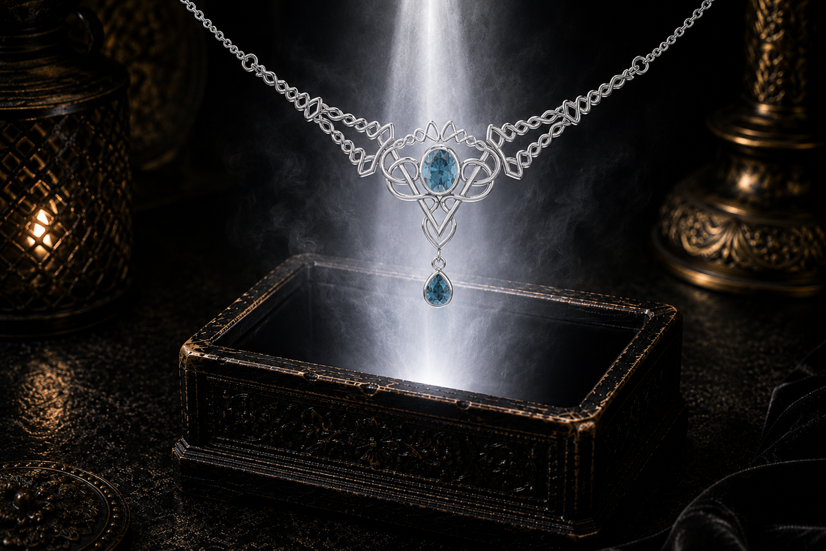 Sterling silver Celtic filigree twist necklace with blue topaz gemstones displayed above a luminous jewelry chest surrounded by soft glowing light and cinematic shadows.