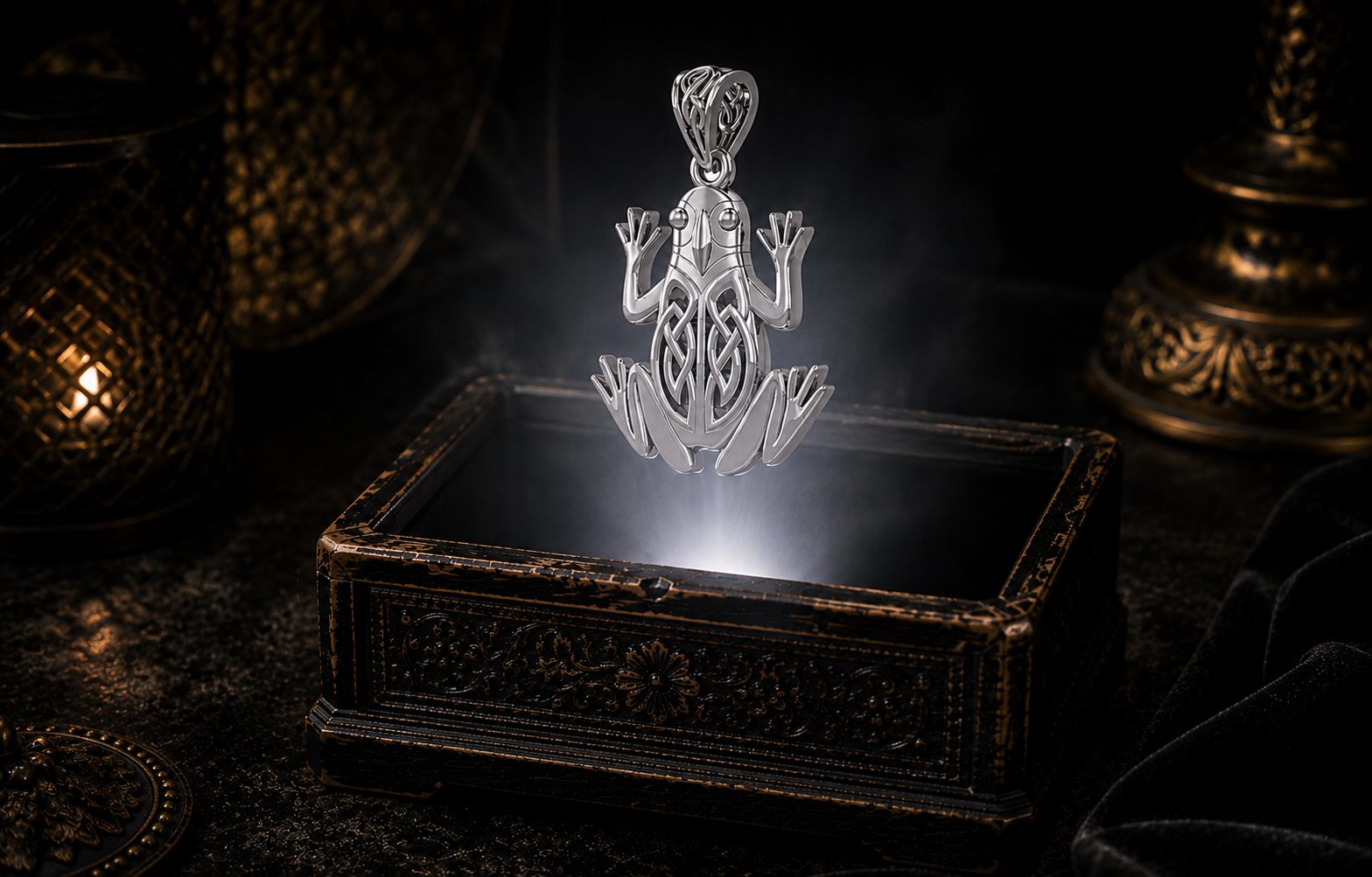 Sterling Silver Celtic Frog Pendant with intricate Celtic knotwork representing healing, sacred waters, transformation, protection, and good fortune, photographed in a cinematic luxury jewelry setting above an antique treasure box.