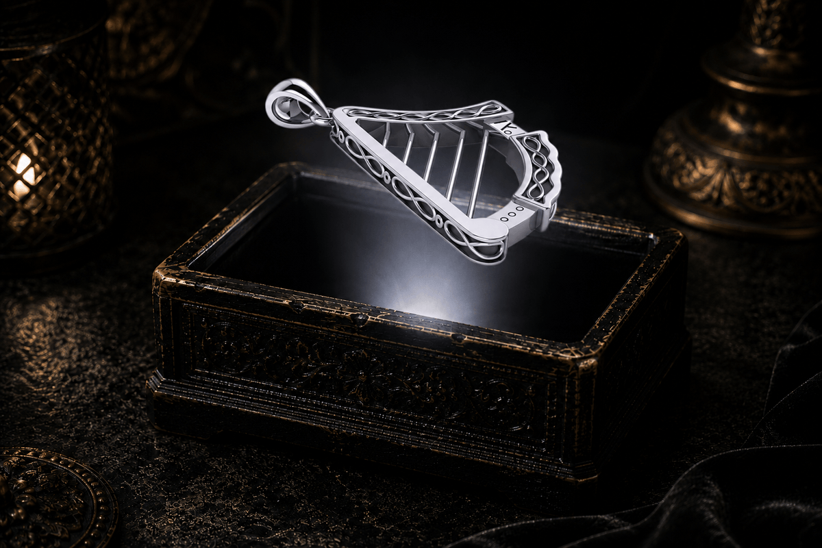 Angled view of a sterling silver Celtic harp pendant showing infinity-like loops along the dimensional outer frame