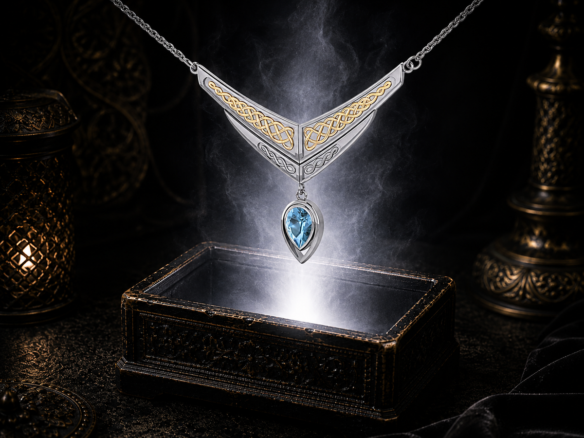 Sterling silver Celtic interlace wing necklace with gold accents and blue topaz gemstone displayed above a luminous jewelry chest with radiant light in a cinematic luxury environment.