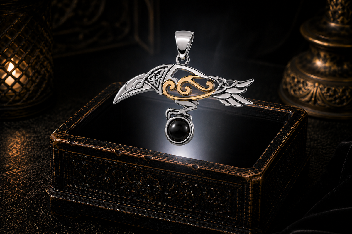 Celtic raven pendant with glossy black onyx gemstone displayed above luxurious dark jewelry box with warm ambient lighting