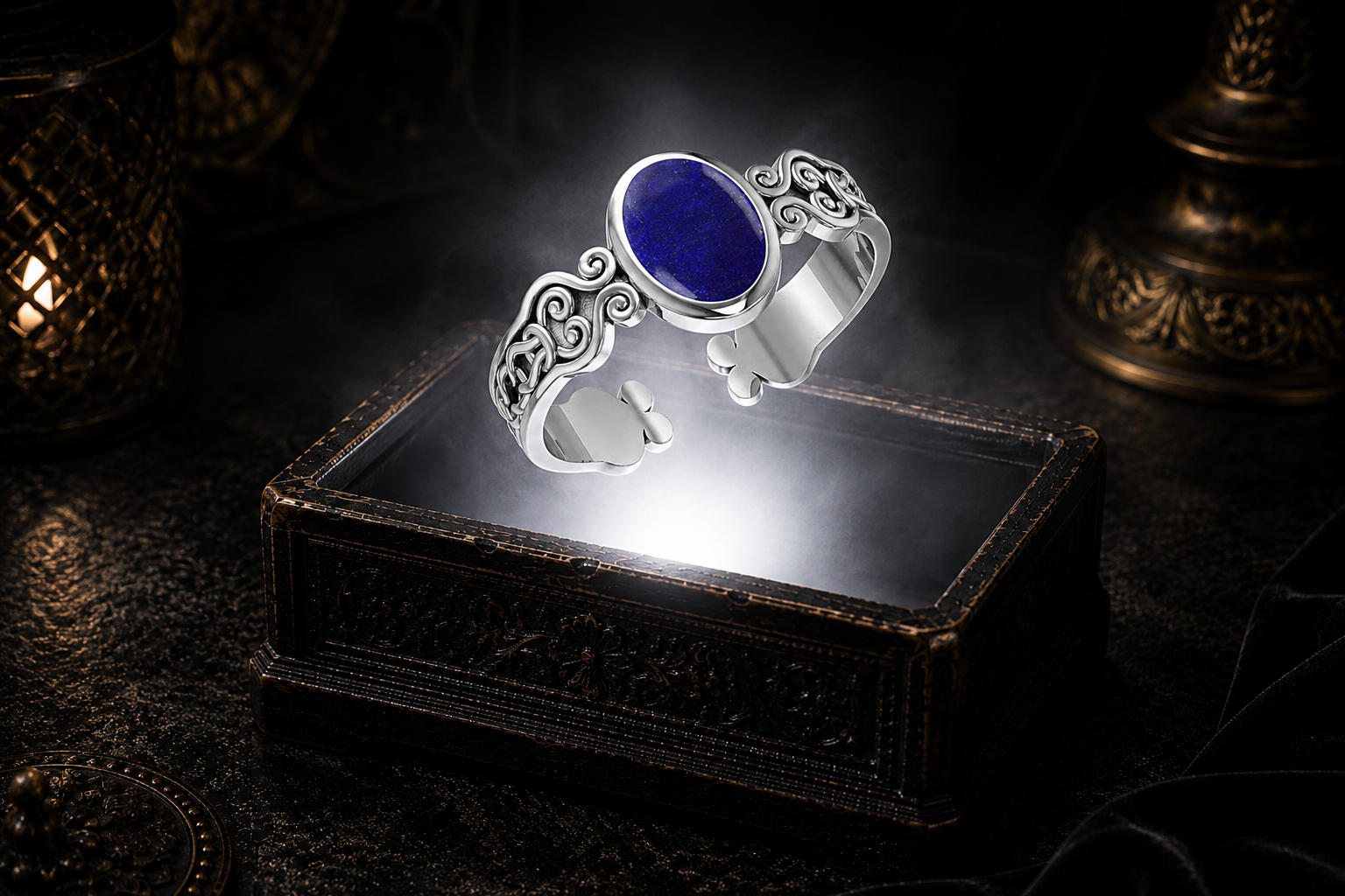Sterling silver Celtic spiral knot cuff bracelet with natural lapis gemstone floating above an ornate jewelry box illuminated by soft white light in a dark luxury setting with deep blue lapis, intricate Celtic scrollwork, cinematic atmosphere, and refined heritage-inspired elegance.