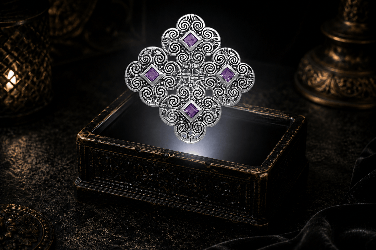 Sterling silver Celtic spiral Triskelia pendant with four square amethyst stones and symmetrical scrollwork, hovering above an ornate jewelry box illuminated by a neutral white beam