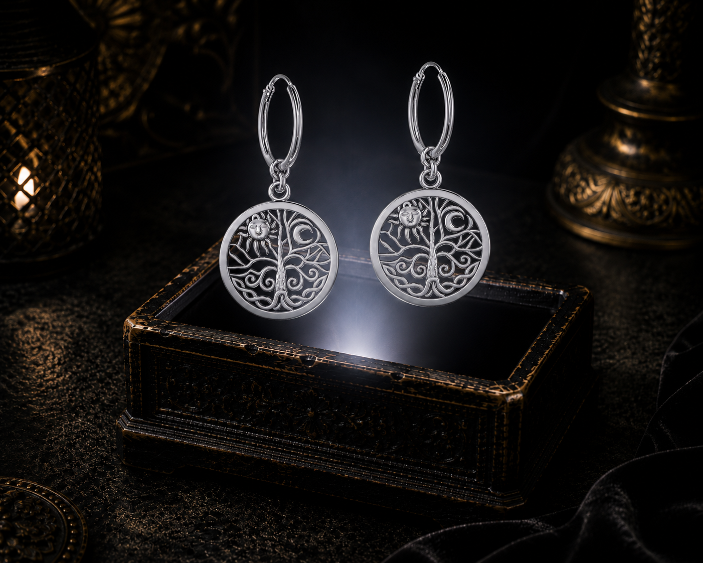 Sterling silver Celtic Tree of Life sun and moon hoop earrings floating above a glowing ornate jewelry box in a dark luxurious mystical setting with cinematic lighting