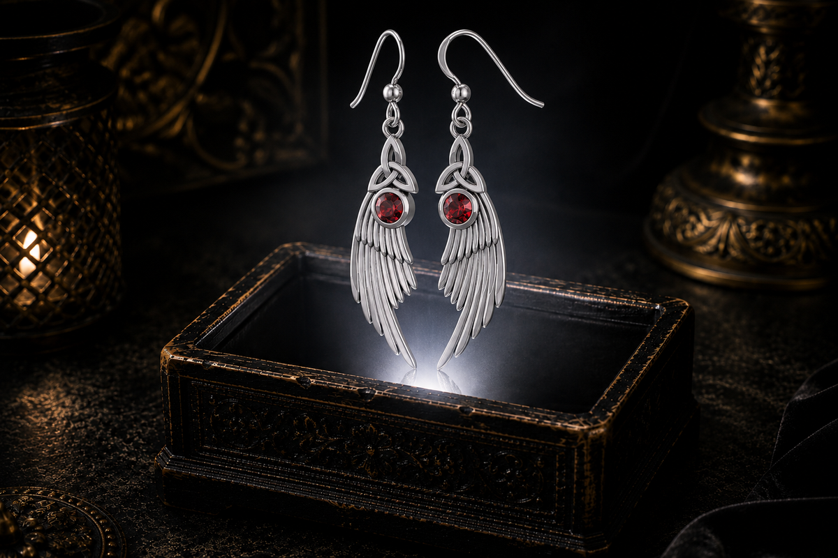 Sterling silver Celtic Trinity Knot angel wing earrings with garnet gemstones floating above a glowing ornate jewelry box in a dark luxurious mystical setting with cinematic lighting