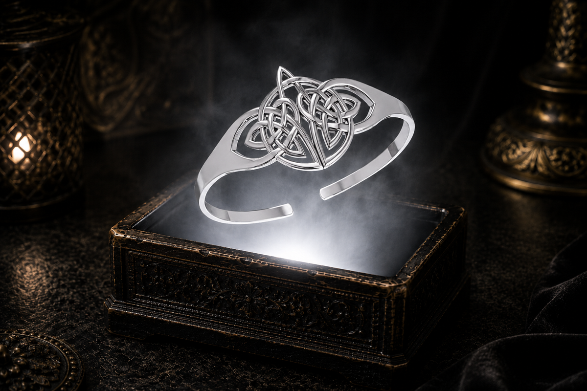 Sterling silver Celtic Trinity Knot cuff bracelet floating above an ornate jewelry box illuminated by soft white light in a dark luxury setting with intricate Celtic knotwork, cinematic atmosphere, and refined heritage-inspired elegance.
