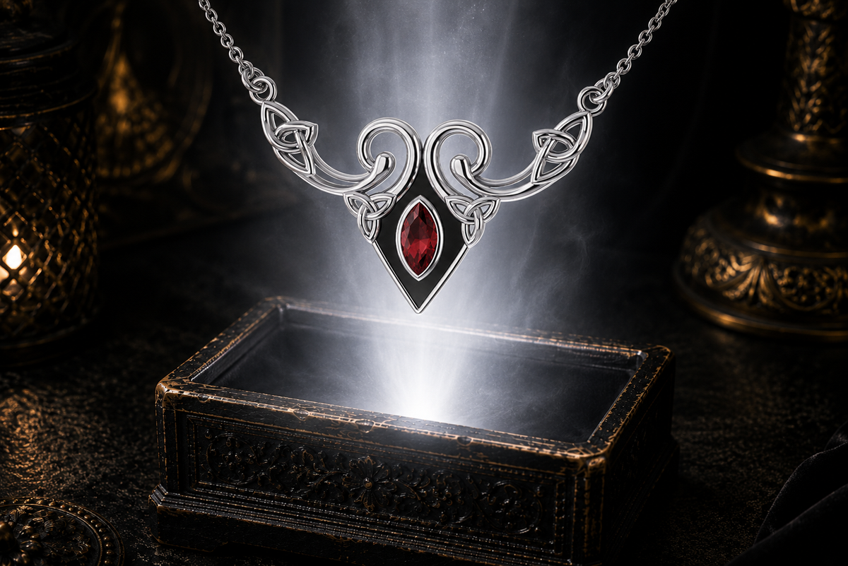 Sterling silver Celtic Triquetra necklace with garnet gemstone displayed above an ornate dark jewelry box surrounded by soft glowing light in a cinematic luxury environment.
