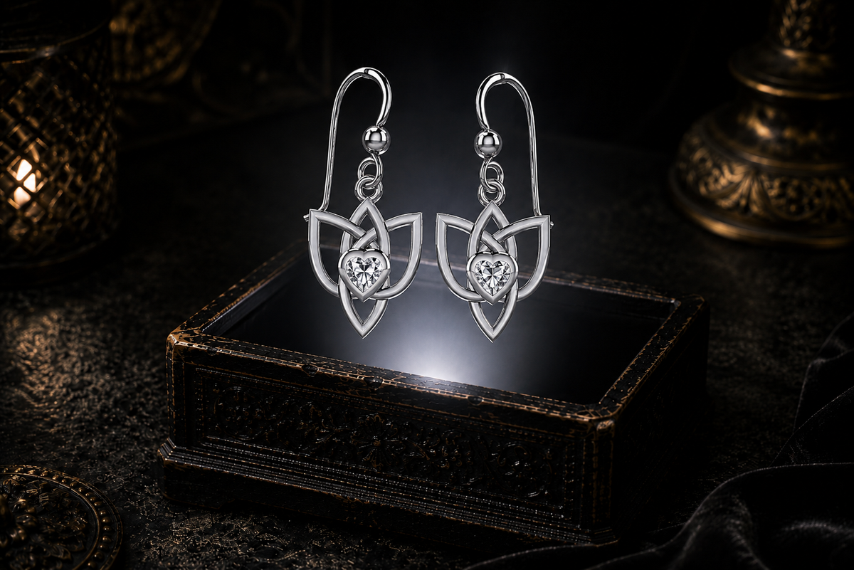 Sterling silver Celtic Triquetra Trinity Knot heart earrings with cubic zirconia heart gemstones floating above a glowing ornate jewelry box in a dark luxurious mystical setting with cinematic lighting