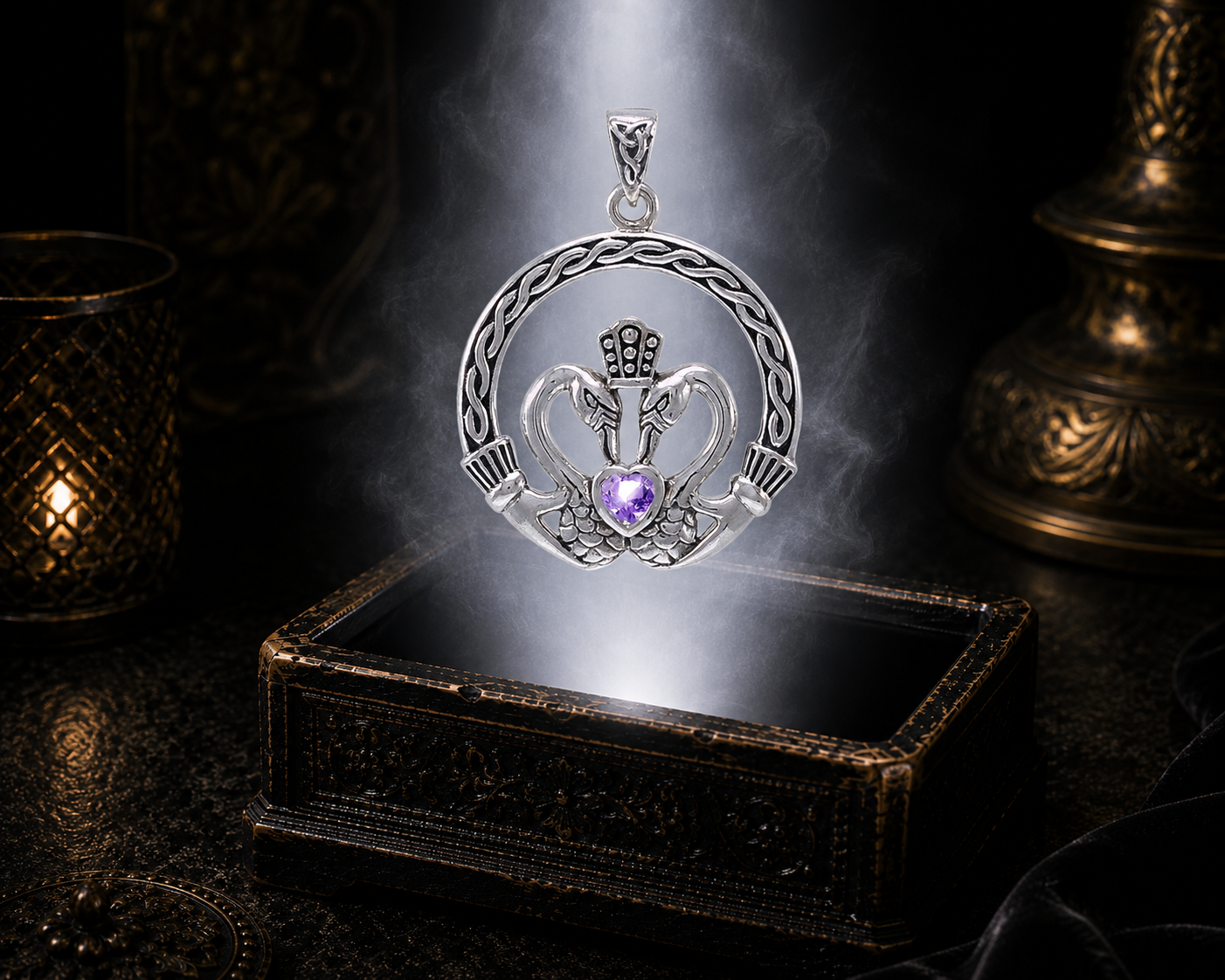 Sterling silver Claddagh swan heart pendant with amethyst gemstone floating above an ornate antique jewelry box illuminated by soft white light in a cinematic luxury environment.