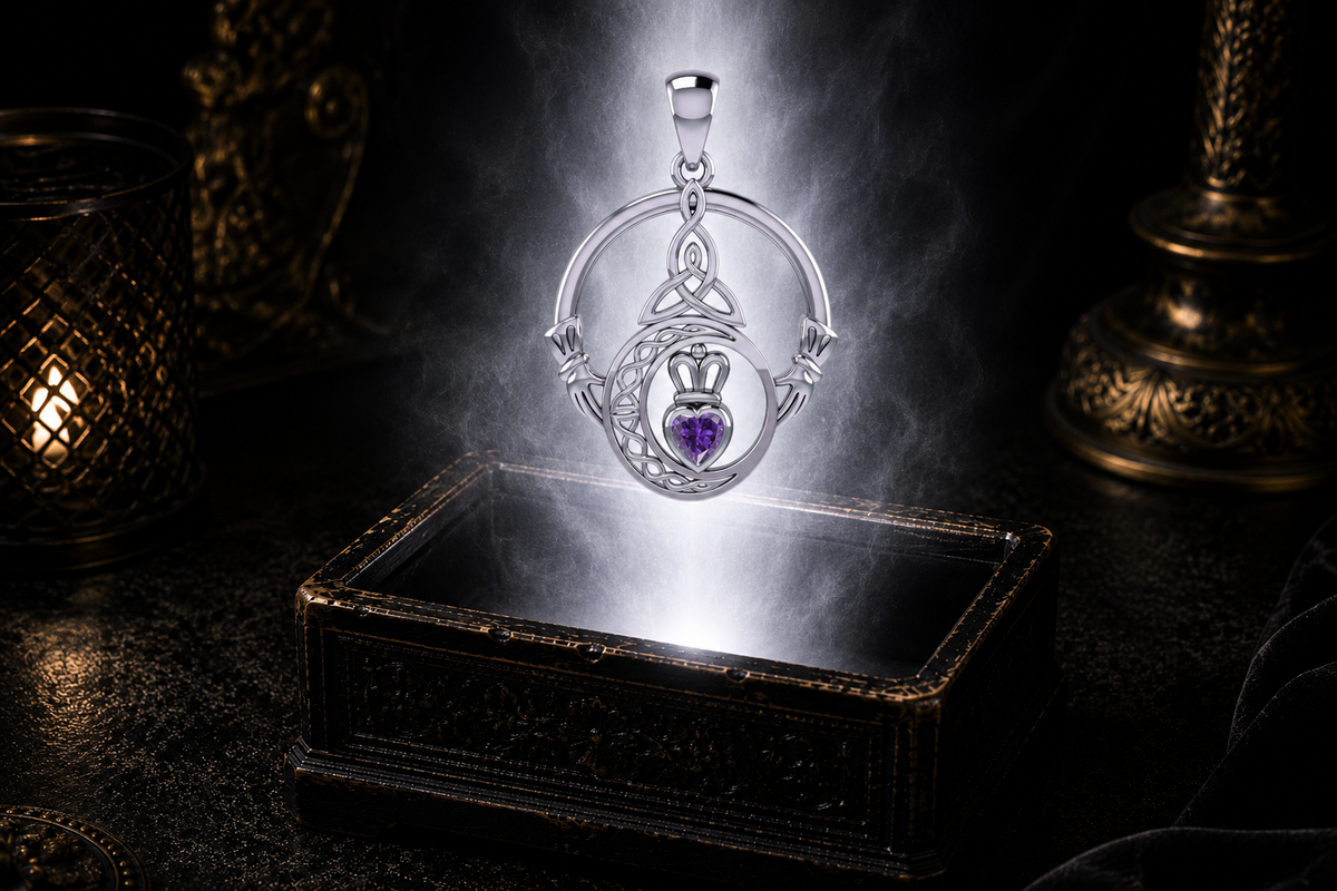 Sterling silver Claddagh Trinity Moon pendant with amethyst gemstone floating above an ornate jewelry box surrounded by soft glowing light in a dark luxury setting, featuring a crescent moon, Trinity Knot, and crowned heart.