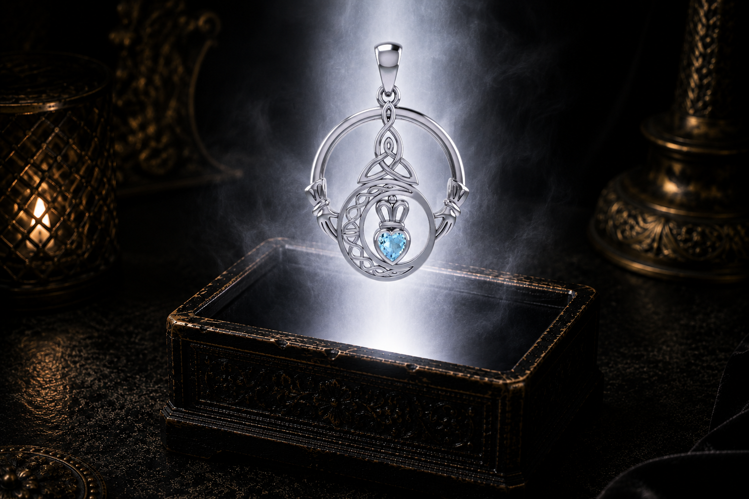 Sterling silver Claddagh Trinity Moon pendant with garnet gemstone suspended above an ornate jewelry box surrounded by soft radiant light in a dark luxury environment, featuring a crowned heart, crescent moon, and Trinity Knot.