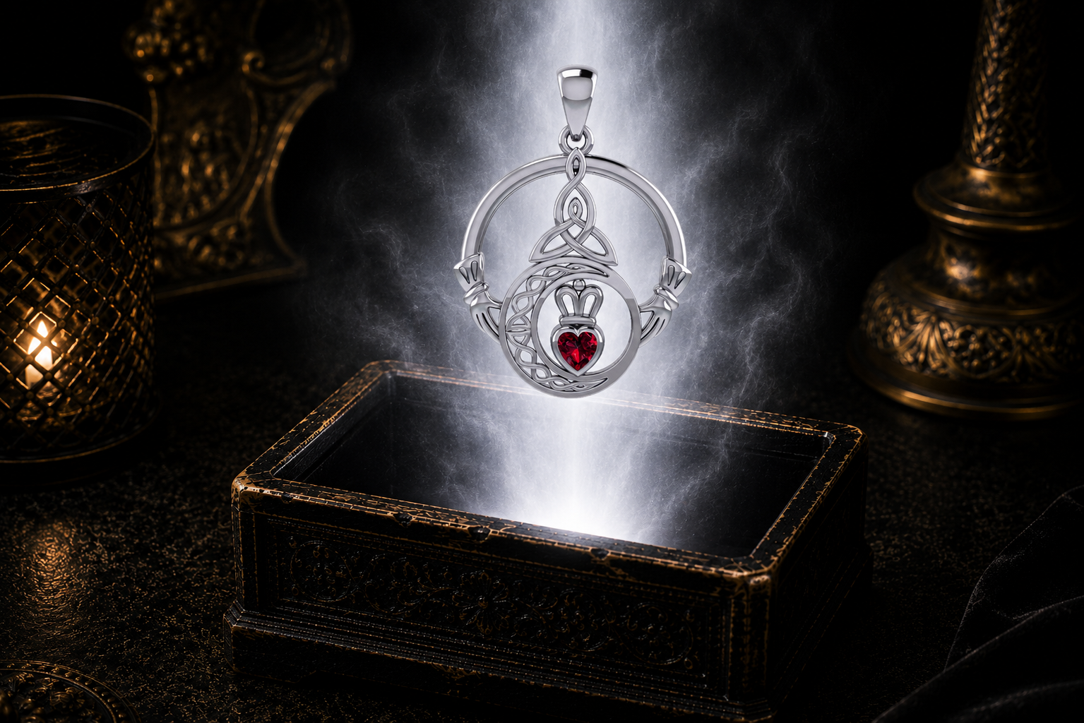 Sterling silver Claddagh Trinity Moon pendant with garnet gemstone suspended above an ornate jewelry box surrounded by soft radiant light in a dark luxury environment, featuring a crowned heart, crescent moon, and Trinity Knot.