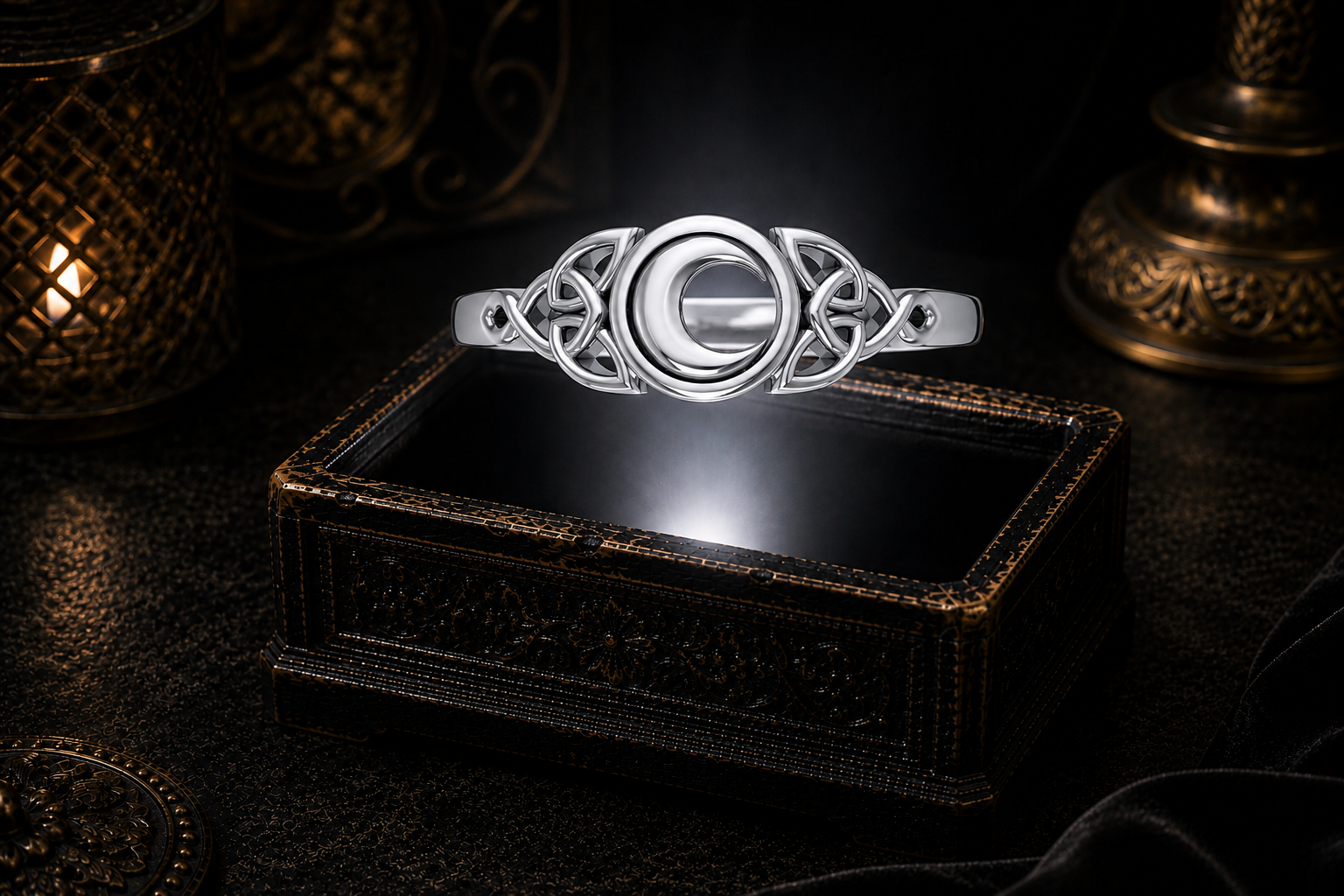Sterling silver crescent moon Celtic ring suspended above an ornate jewelry box within a soft white beam of light in a cinematic luxury setting.