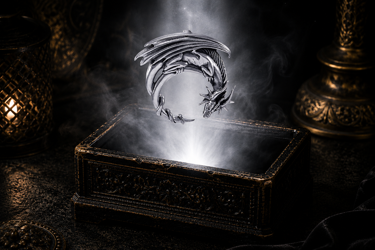 Sterling silver crescent moon dragon Celtic guardian pendant floating above an ornate dark jewelry box surrounded by luminous white light and drifting mist in a cinematic luxury setting.