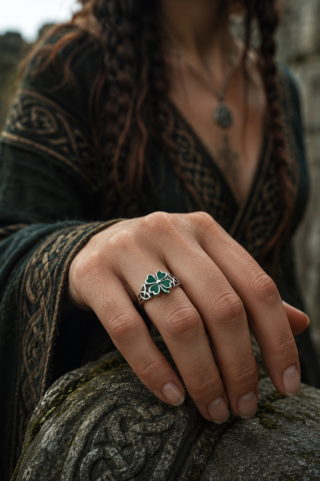 Celtic woman wearing an enchanted four leaf clover sterling silver ring with green enamel in a mystical Celtic-inspired setting