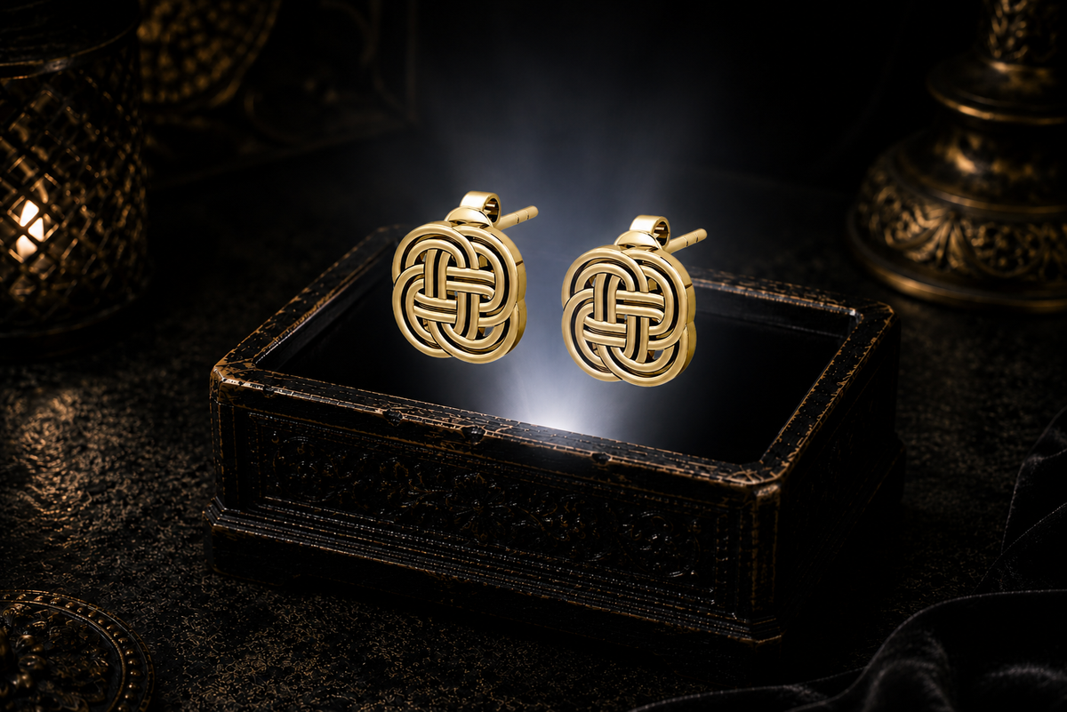 14K solid gold Celtic knot stud earrings floating above a glowing ornate jewelry box in a dark luxury setting