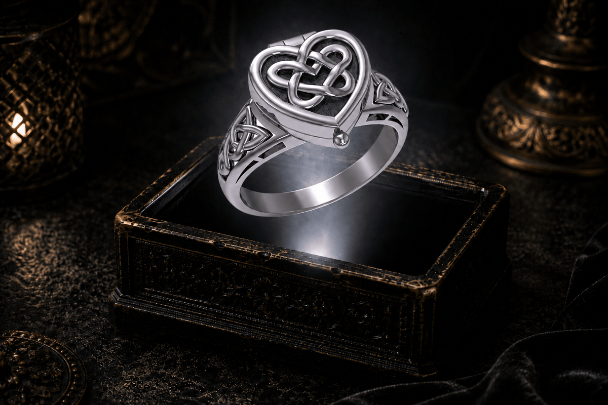Sterling silver heart-shaped poison ring with Celtic knotwork floating above an ornate jewelry box