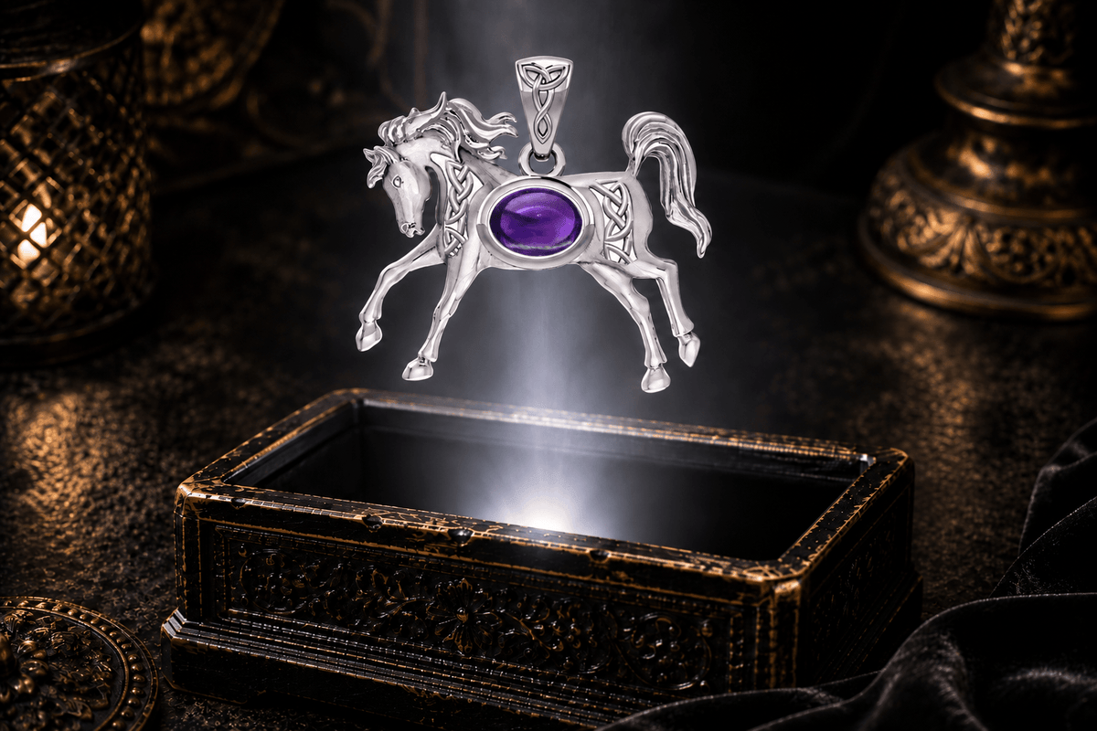 14K white gold running horse pendant with oval amethyst, Celtic knotwork and flowing mane hovering above an antique jewelry box.