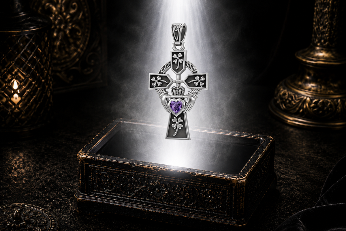 Sterling silver Irish Claddagh Cross pendant with Four Leaf heart design and amethyst heart gemstone floating above an ornate jewelry box surrounded by soft glowing light in a dark luxury setting.