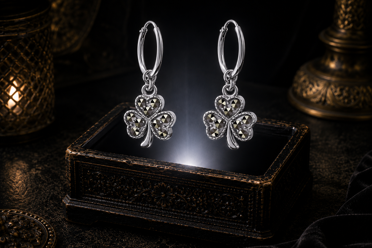 Sterling silver shamrock hoop earrings with marcasite stones floating above a glowing ornate jewelry box in a dark luxurious mystical setting with soft cinematic lighting