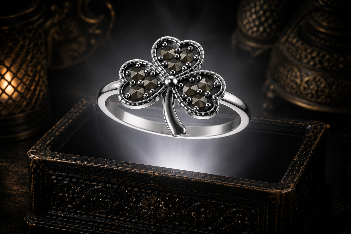 Lucky sterling silver Celtic shamrock ring with marcasite floating above an illuminated antique jewelry box in a dark mystical Celtic setting