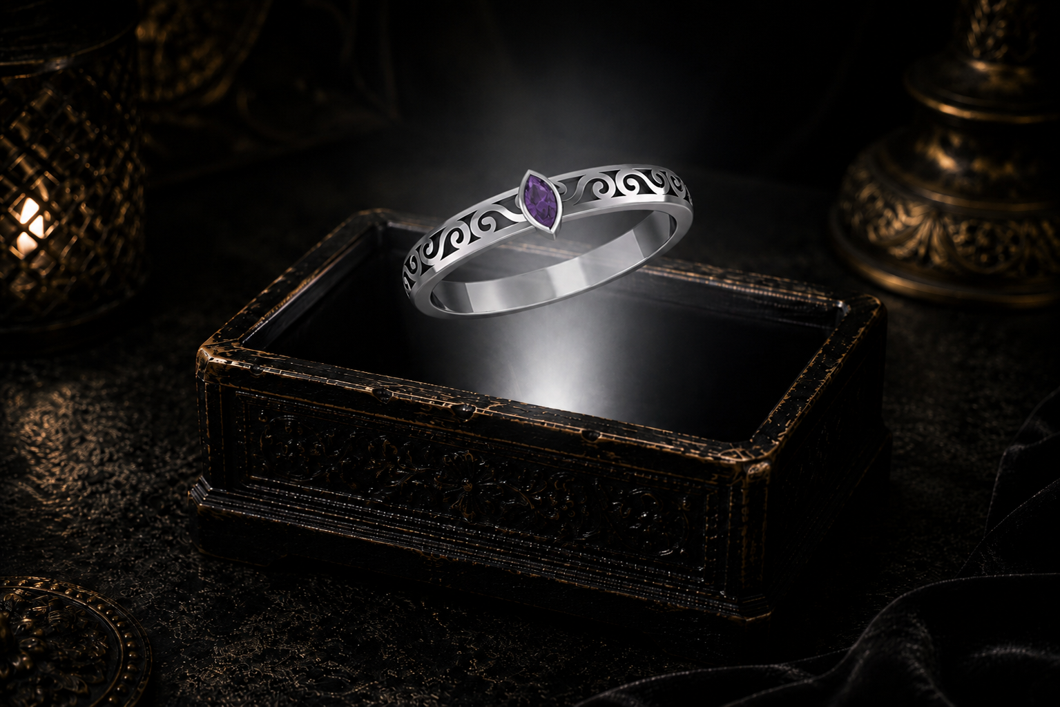 Garnet marquise sterling silver filigree ring hovering above an antique jewelry box surrounded by soft atmospheric lighting.