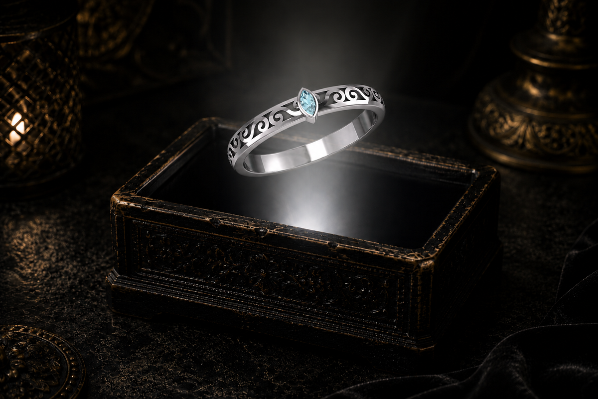 Blue topaz marquise sterling silver ring with openwork scrolls suspended over an ornate keepsake box in a cinematic luxury setting.