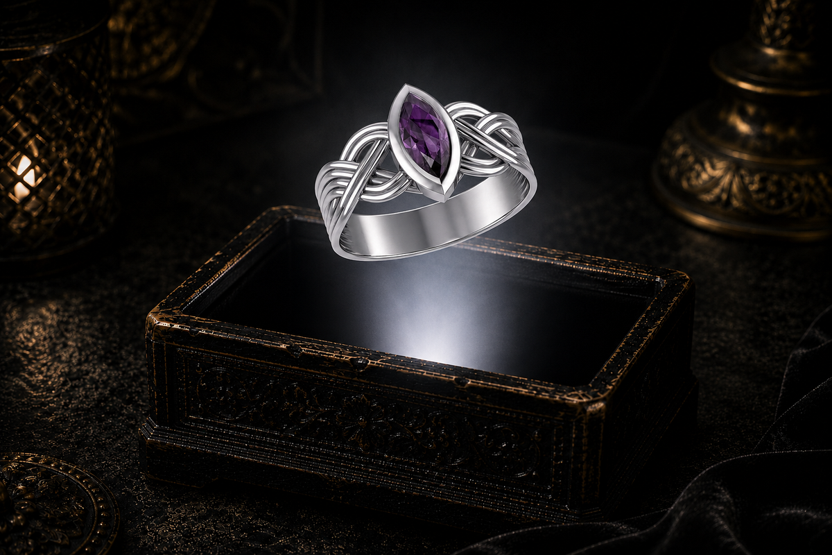 Sterling silver Celtic interwoven strand ring with a marquise-cut amethyst floating above an antique jewelry box in a cinematic luxury setting illuminated by a soft white beam of light.
