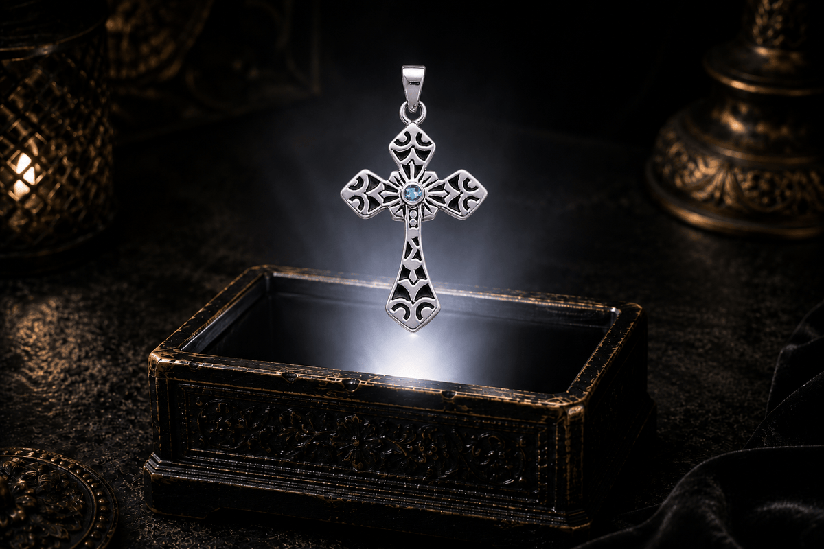 Medieval-inspired sterling silver cross pendant with a Blue Topaz gemstone floating within a neutral white beam over an antique coffer